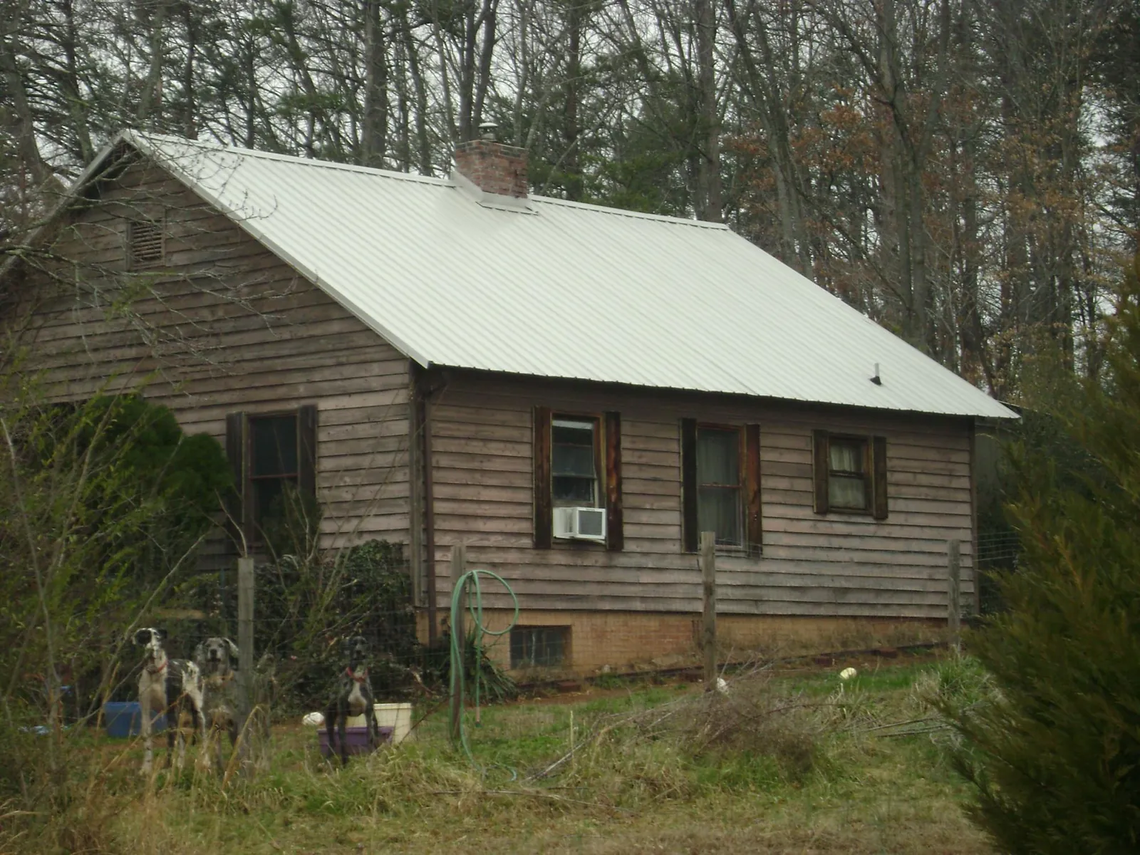 White metal roof on an old wood sided farmhouse, from a Asphalt Shingle Roof Repair job in Big Bear City